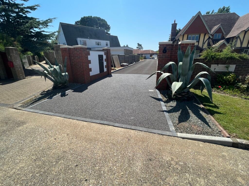 long tarmac drive with brickwork and resin crossover